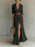 Woman wearing a black long sleeve collared dress - lifestyle photo