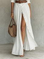 Woman wearing a white long sleeve collared dress - lifestyle photo