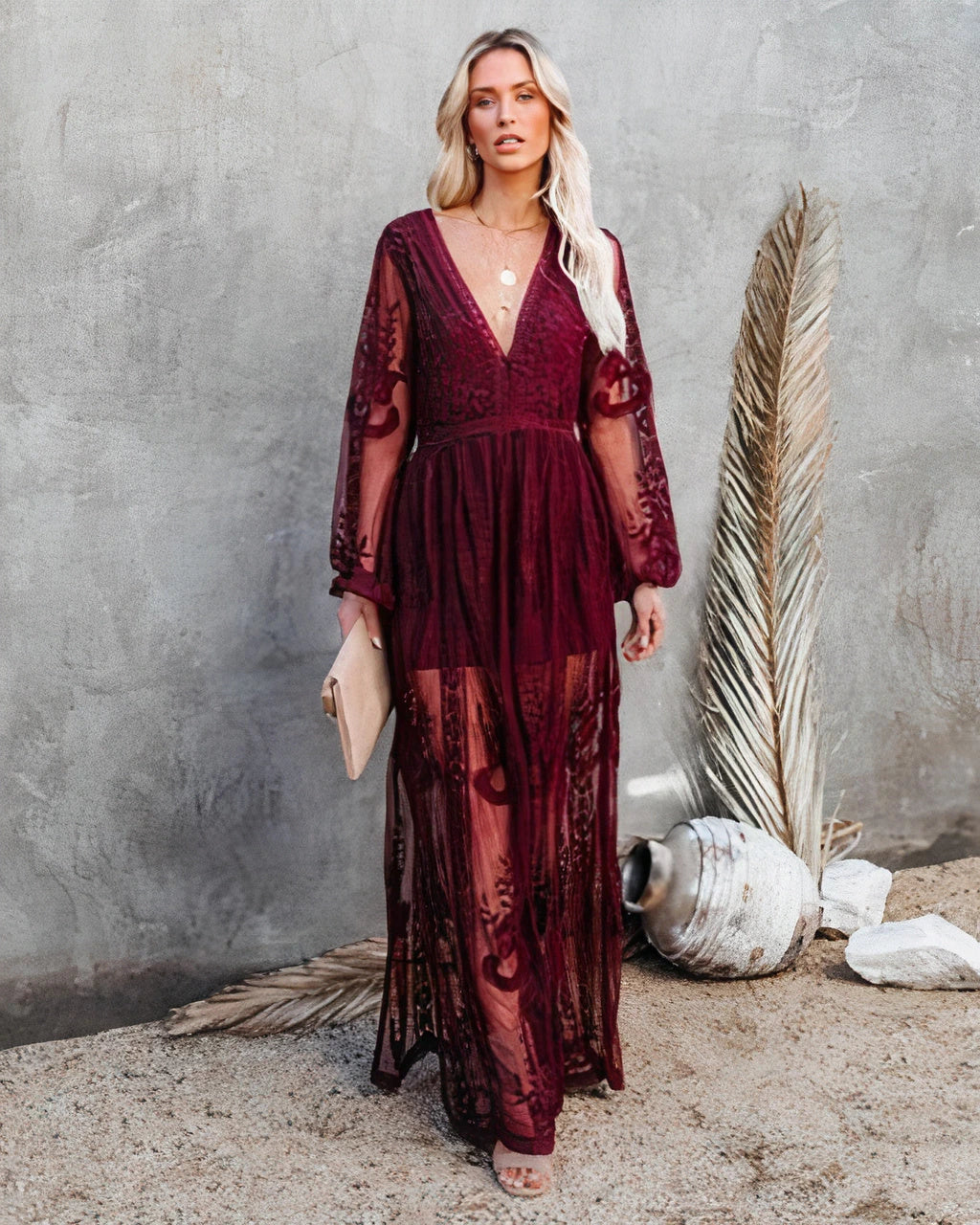 Woman wearing a burgundy long sleeve lace maxi dress - outdoor lifestyle photo
