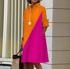 Woman wearing an orange and pink color-block long sleeve midi dress - outdoor lifestyle photo