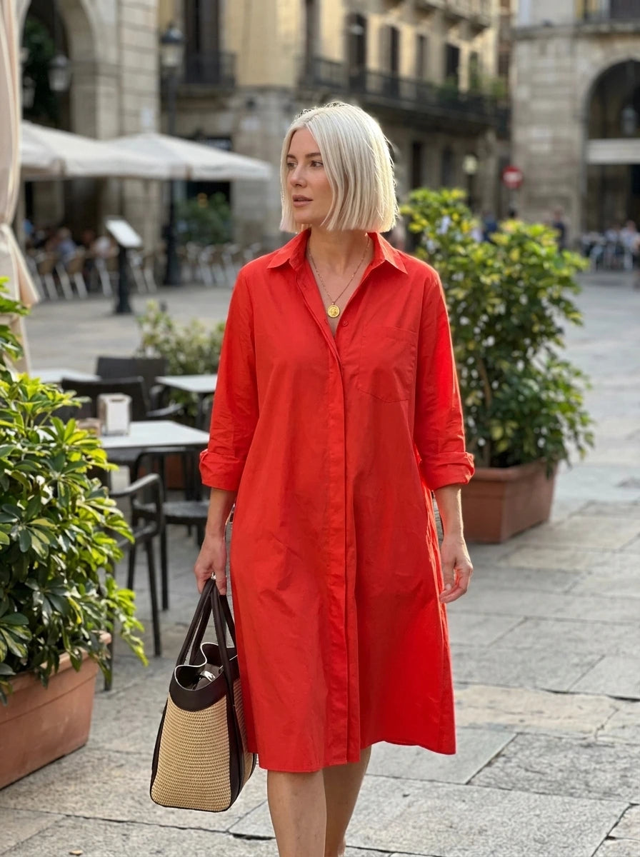 Woman wearing a red long sleeve midi dress on a city street