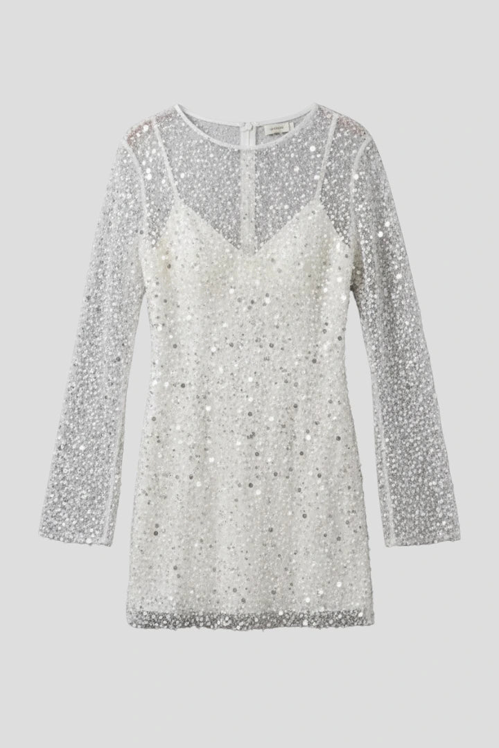 Woman wearing a white mesh overlay sleeveless mini dress - studio photo