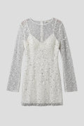 Woman wearing a white mesh overlay sleeveless mini dress - studio photo
