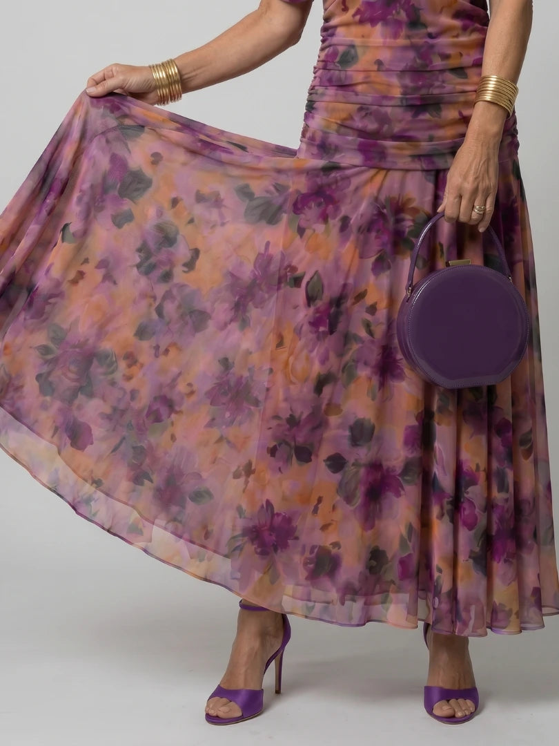 Woman wearing a brown off-shoulder draped midi dress - editorial style photo