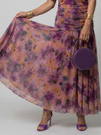 Woman wearing a brown off-shoulder draped midi dress - editorial style photo