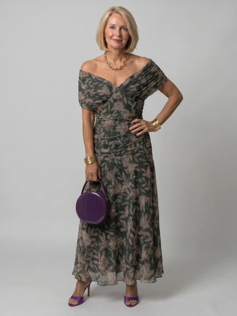Woman wearing a dark green off-shoulder draped midi dress - editorial style photo