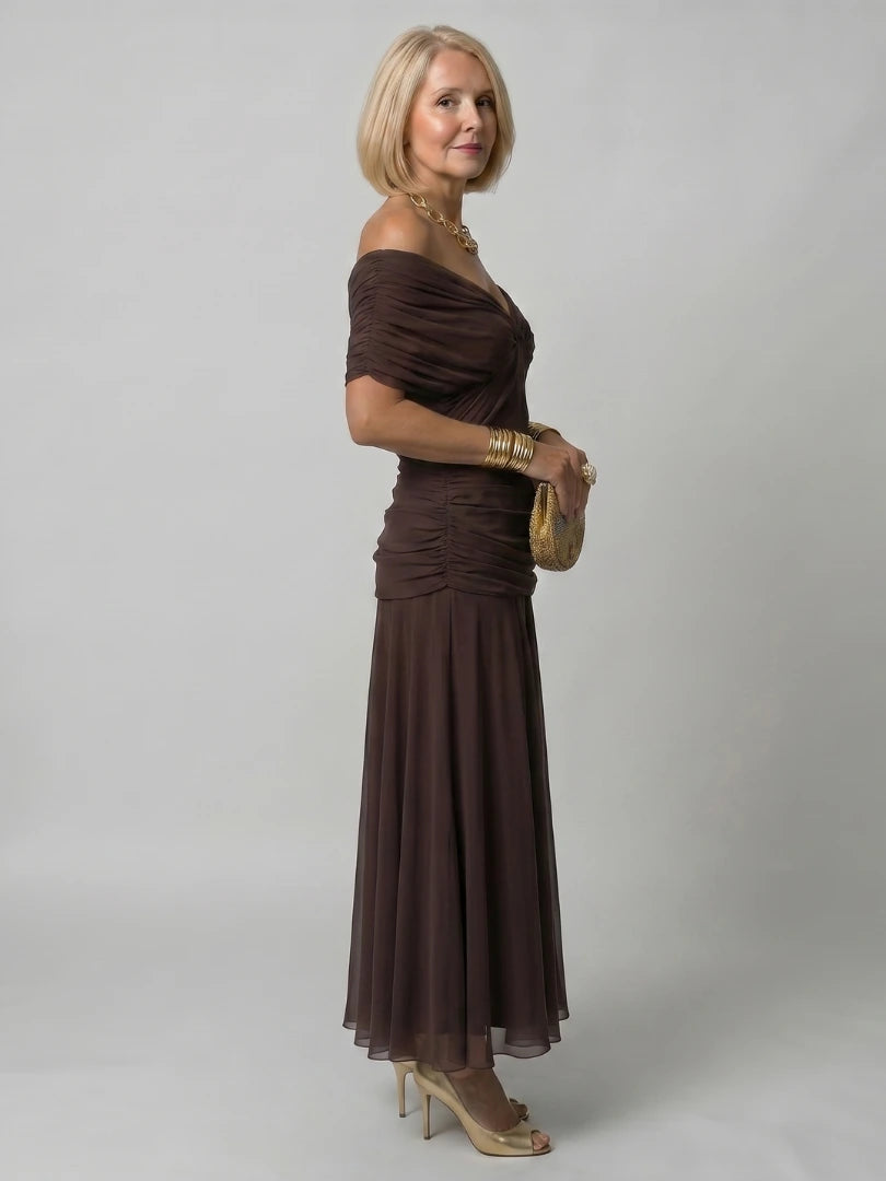 Woman wearing a dark green off-shoulder draped midi dress - editorial style photo
