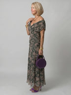 Woman wearing a multicolor off-shoulder draped midi dress - editorial style photo