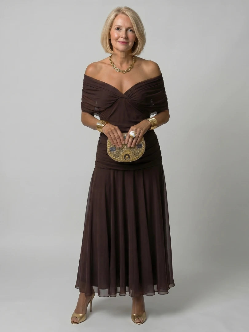 Woman wearing a purple off-shoulder draped midi dress - studio photo