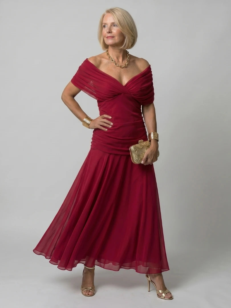 Woman wearing a red off-shoulder draped midi dress - editorial style photo