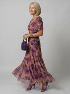 Woman wearing a red off-shoulder draped midi dress - editorial style photo