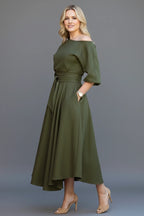 Woman wearing a green off-shoulder lantern sleeve midi dress - lifestyle photo