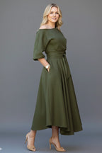Woman wearing a green off-shoulder lantern sleeve midi dress - lifestyle photo