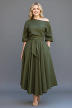 Woman wearing a green off-shoulder lantern sleeve midi dress - studio photo