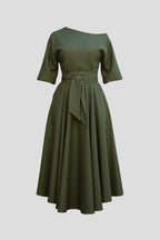 Woman wearing a green off-shoulder lantern sleeve midi dress - studio photo