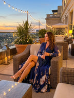 Woman wearing a navy pleated sheer sleeves maxi dress - editorial style photo