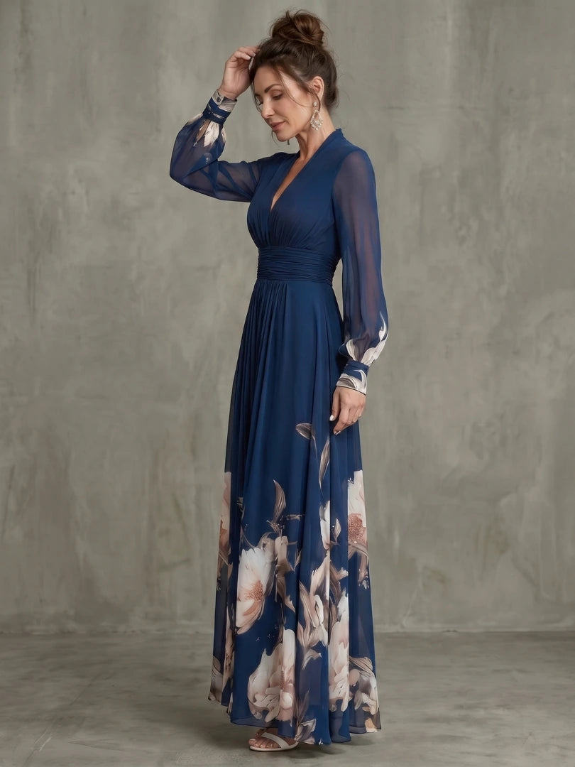 Woman wearing a navy pleated sheer sleeves maxi dress - studio photo