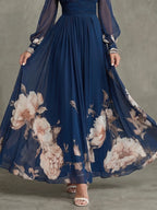 Woman wearing a navy pleated sheer sleeves maxi dress - studio photo