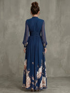 Woman wearing a navy pleated sheer sleeves maxi dress - studio photo