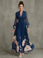 Woman wearing a navy pleated sheer sleeves maxi dress - studio photo