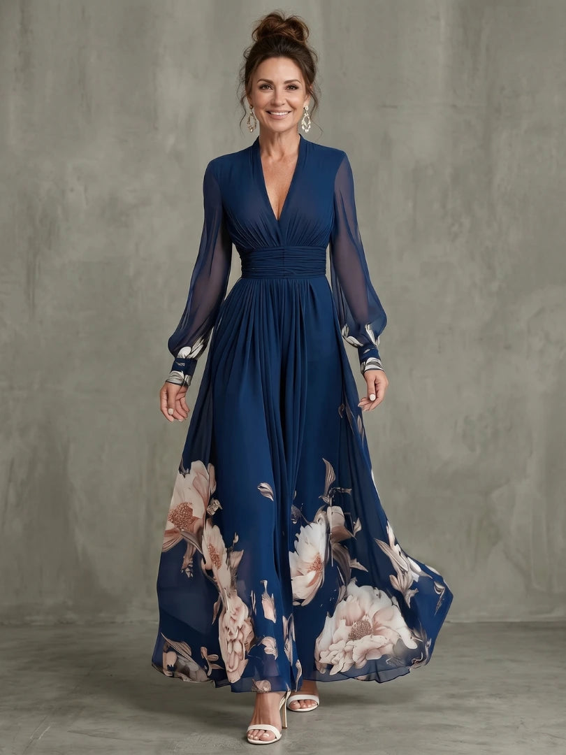 Woman wearing a navy pleated sheer sleeves maxi dress - studio photo