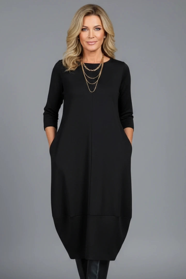 Woman wearing a black round neck pocket midi dress - studio photo