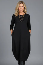 Woman wearing a black round neck pocket midi dress - studio photo