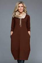 Woman wearing a brown round neck pocket midi dress - studio photo