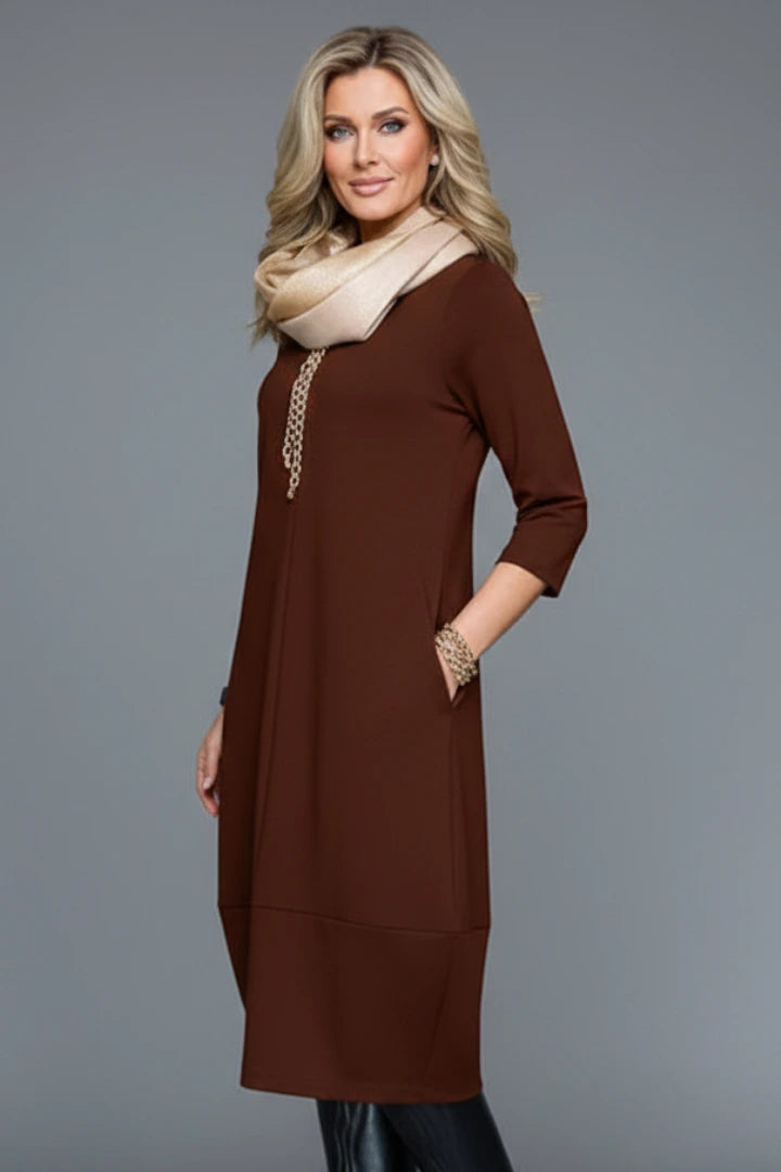 Woman wearing a brown round neck pocket midi dress - studio photo