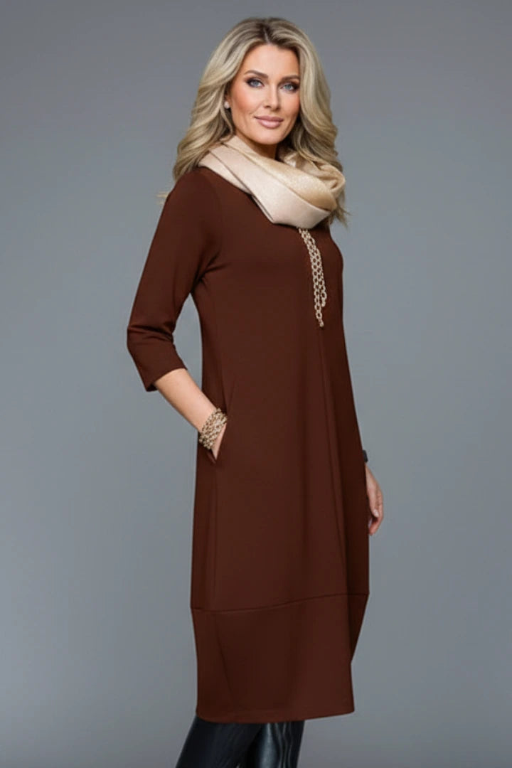 Woman wearing a brown round neck pocket midi dress - studio photo