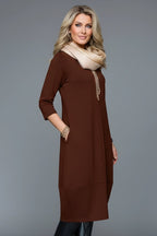 Woman wearing a brown round neck pocket midi dress - studio photo