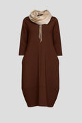Woman wearing a brown round neck pocket midi dress - studio photo