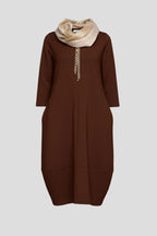Woman wearing a brown round neck pocket midi dress - studio photo