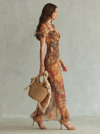 Woman wearing a multicolour ruffled sleeve ruched slit midi dress - studio photo