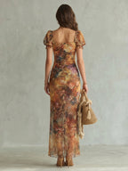 Woman wearing a multicolour ruffled sleeve ruched slit midi dress - studio photo