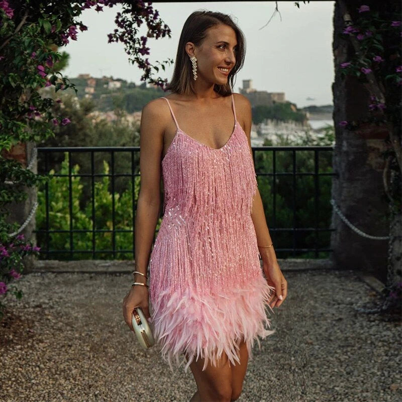 Woman wearing a dark pink sequin spaghetti strap fitted dress - editorial style photo