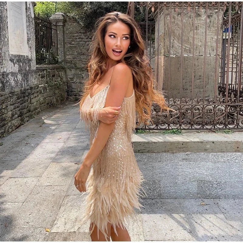 Woman wearing a gold sequin spaghetti strap fitted dress - editorial style photo