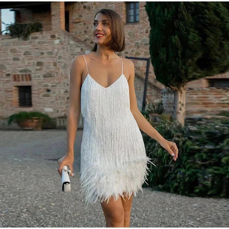 Woman wearing a white sequin spaghetti strap fitted dress - editorial style photo