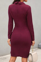 Woman wearing a black sheath mini dress - studio photo