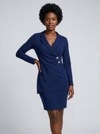 Woman wearing a blue sheath mini dress in a studio setting