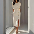 Woman wearing a white side button midi split hem dress - lifestyle photo