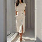 Woman wearing a white side button midi split hem dress - lifestyle photo