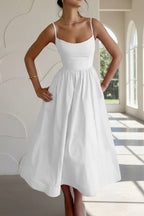 Woman wearing a white sleeveless cocktail midi dress - outdoor lifestyle photo