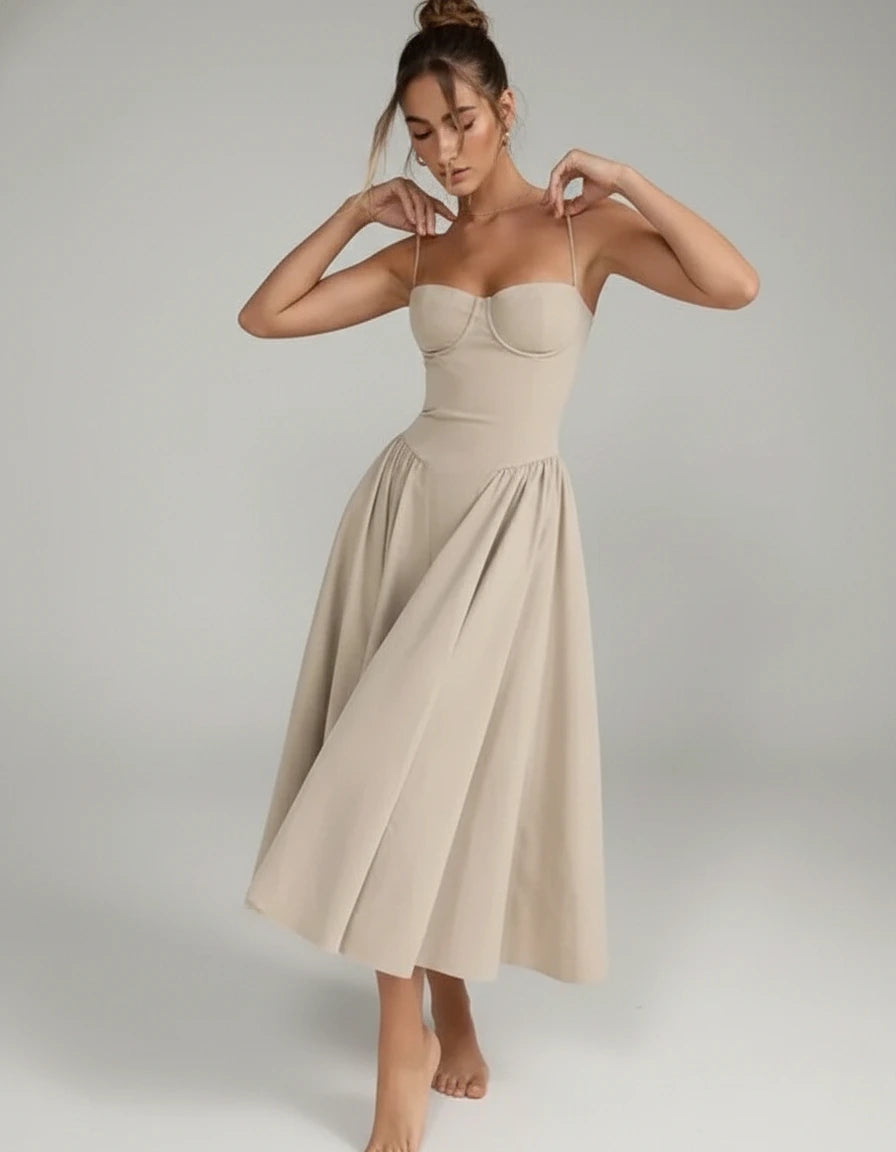 Woman wearing a beige sleeveless corset style midi dress - studio photo