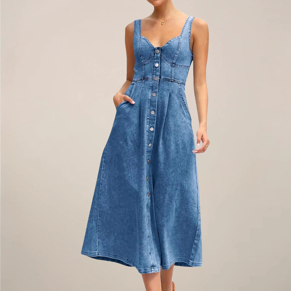 Woman wearing a dark blue sleeveless denim midi dress - studio photo