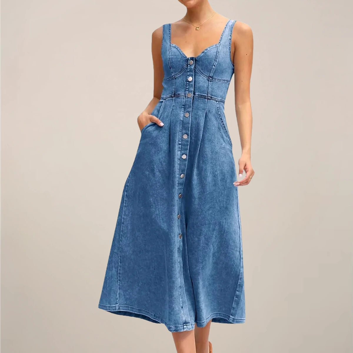 Woman wearing a dark blue sleeveless denim midi dress - studio photo