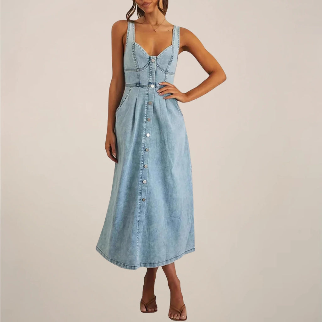 Woman wearing a light blue sleeveless denim midi dress - studio photo