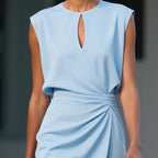Woman wearing a light blue sleeveless elegant midi dress - studio photo
