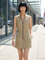 Woman wearing a khaki sleeveless zip-front cargo dress on a city street