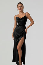 Woman wearing a black slim strap draped dress - studio photo